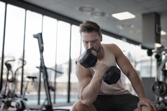  Boost Your Prostate Health: Man at gym doing dumbbell curls
