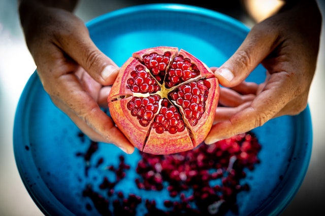 Testosterone Boosting Fruits: pomegranates fruit over plate